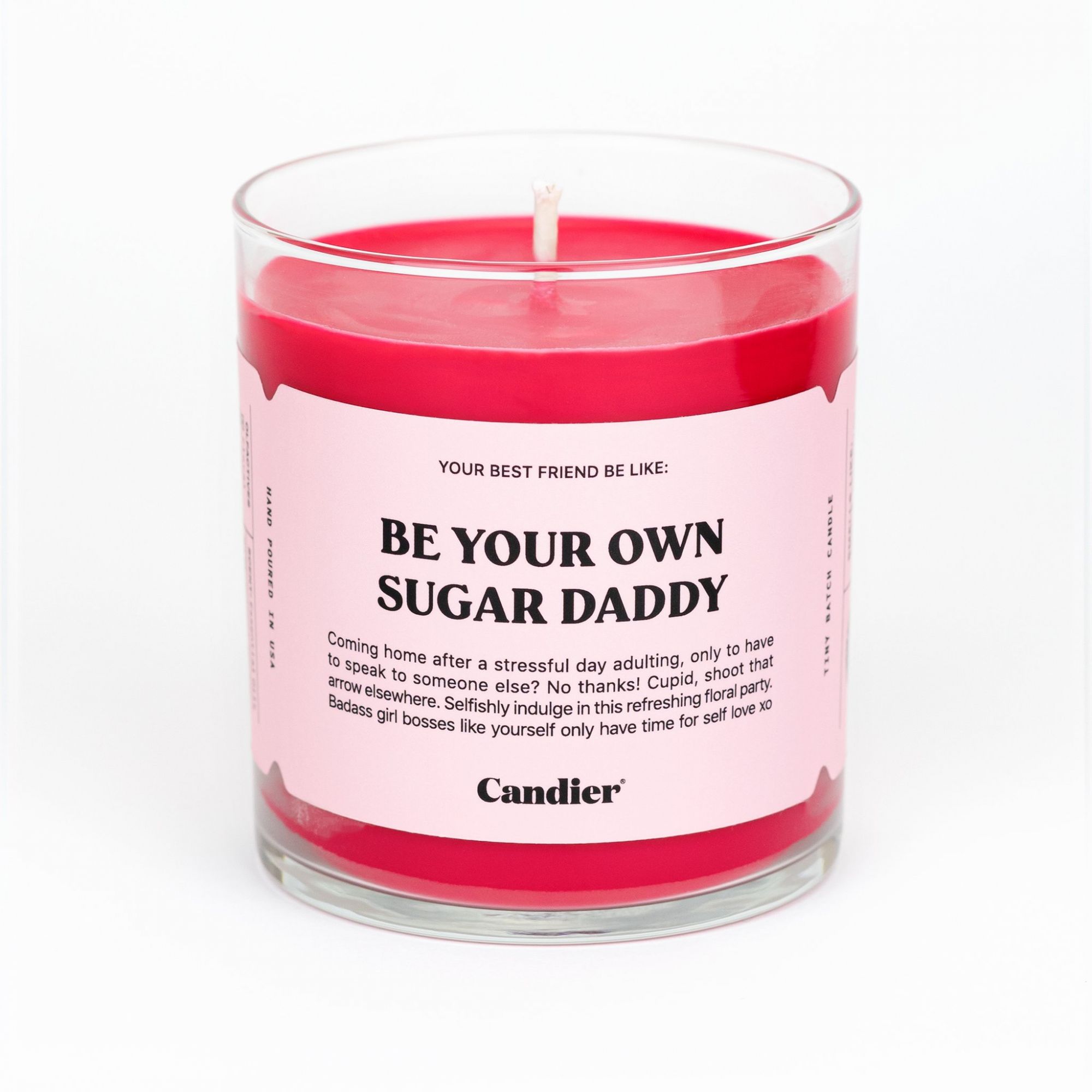 A pink candle called Be Your Own Sugar Daddy.