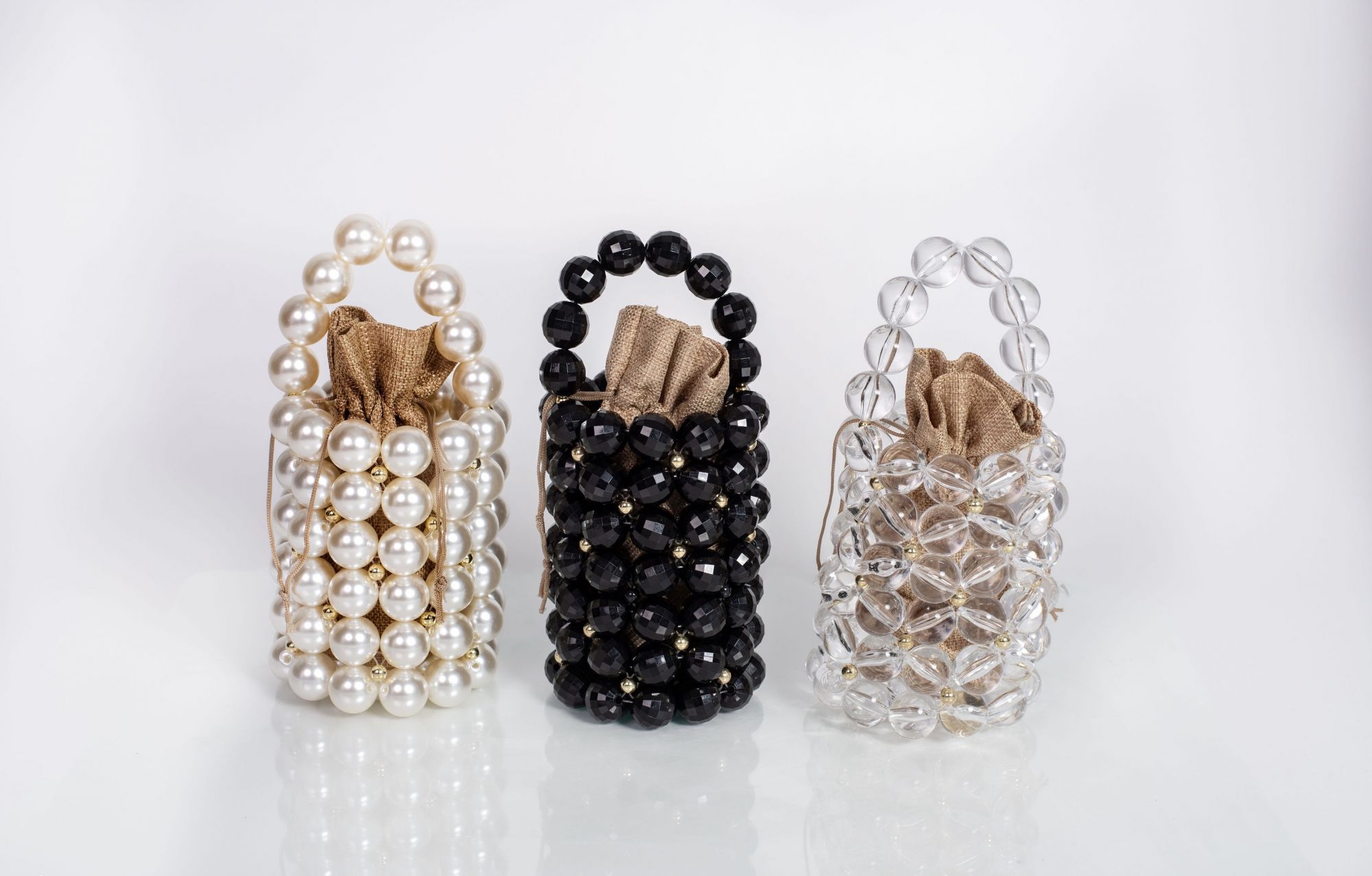 Three Abi bags: Pearl, Black and Clear.