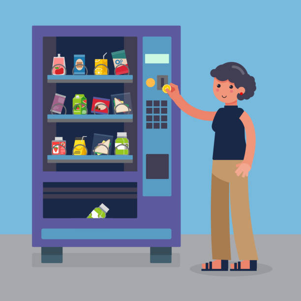 Woman inserts a coin in a healthy snack vending machine.